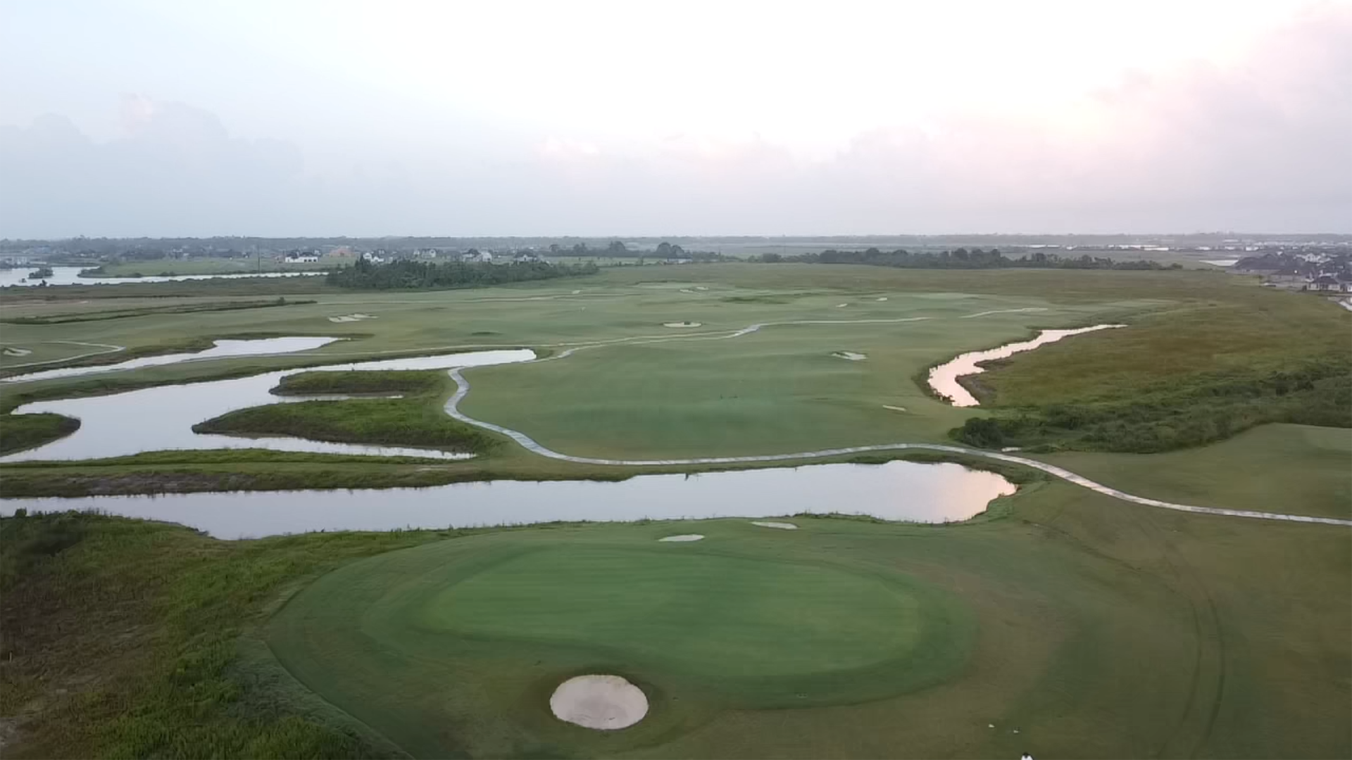 Image of golf ball on tee on grass.